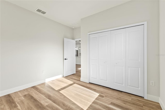 178 Marion Oaks Ln, Ocala, FL 34473 - unfurnished bedroom with light wood finished floors, baseboards, and a closet