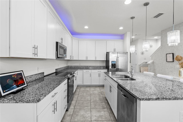 11054 Hanlon Terrace Aly, Winter Garden, FL 34787 - kitchen with appliances with stainless steel finishes, a sink, a chandelier, an island with sink, and white cabinetry