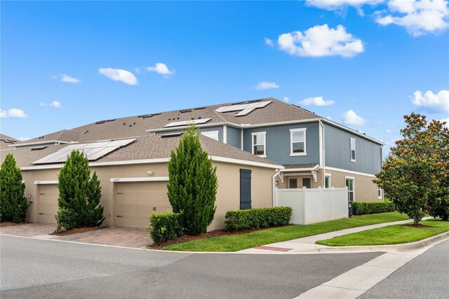 11054 Hanlon Terrace Aly, Winter Garden, FL 34787 - view of front of property with stucco siding, solar panels, decorative driveway, an attached garage, and roof with shingles