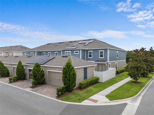 11054 Hanlon Terrace Aly, Winter Garden, FL 34787 - multi unit property with solar panels, a residential view, an attached garage, stucco siding, and driveway