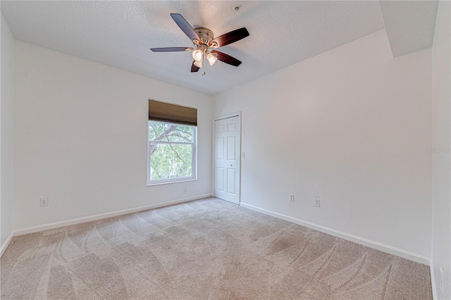 5500 Metrowest Blvd Unit 203, Orlando, FL 32811 - spare room with light colored carpet, baseboards, a ceiling fan, and a textured ceiling