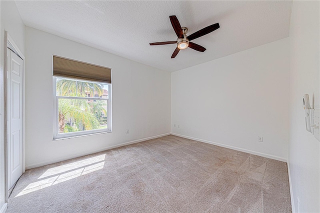 5500 Metrowest Blvd Unit 203, Orlando, FL 32811 - unfurnished room featuring a ceiling fan, carpet floors, baseboards, and a textured ceiling