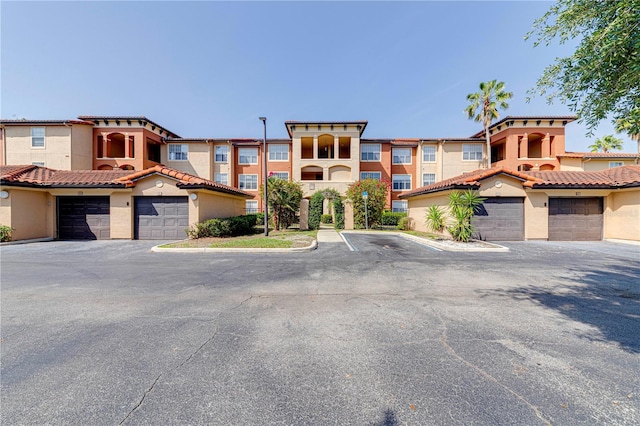 5500 Metrowest Blvd Unit 203, Orlando, FL 32811 - view of front of house with stucco siding and a tile roof