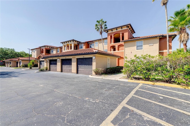 5500 Metrowest Blvd Unit 203, Orlando, FL 32811 - view of front of property featuring stucco siding and a tile roof