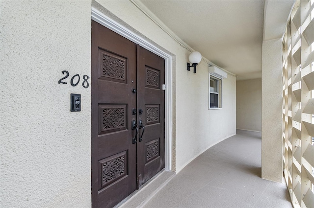 4850 Ocean Beach Blvd Unit 208, Cocoa Beach, FL 32931 - view of exterior entry with french doors and stucco siding
