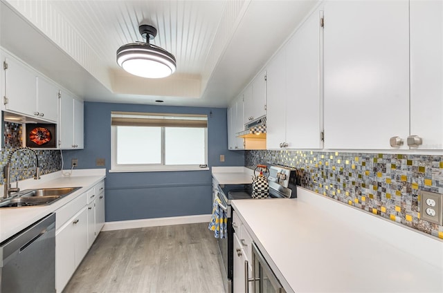 4850 Ocean Beach Blvd Unit 208, Cocoa Beach, FL 32931 - kitchen featuring stainless steel appliances, a sink, light wood-style floors, and white cabinetry