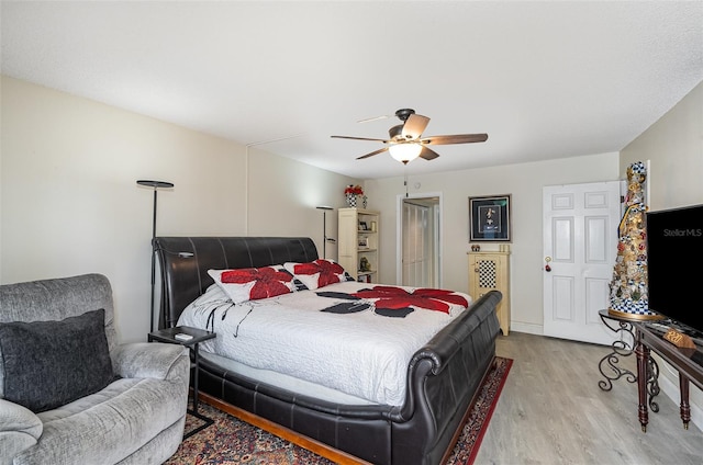 4850 Ocean Beach Blvd Unit 208, Cocoa Beach, FL 32931 - bedroom with light wood-style flooring and ceiling fan