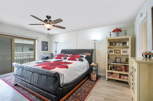 4850 Ocean Beach Blvd Unit 208, Cocoa Beach, FL 32931 - bedroom featuring light wood-style floors, access to outside, ceiling fan, and baseboards