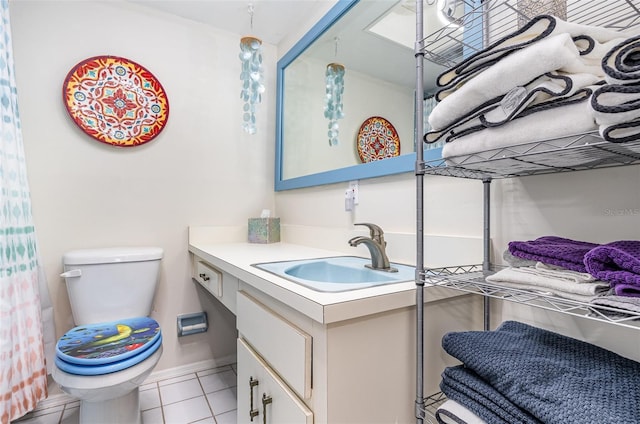 4850 Ocean Beach Blvd Unit 208, Cocoa Beach, FL 32931 - full bathroom with vanity, toilet, tile patterned floors, and baseboards
