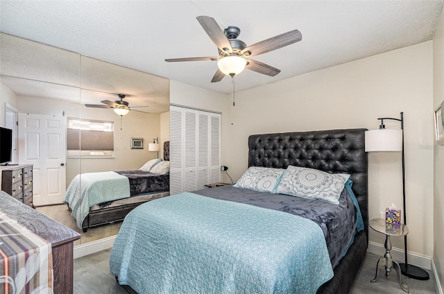 4850 Ocean Beach Blvd Unit 208, Cocoa Beach, FL 32931 - bedroom featuring wood finished floors, baseboards, and a ceiling fan