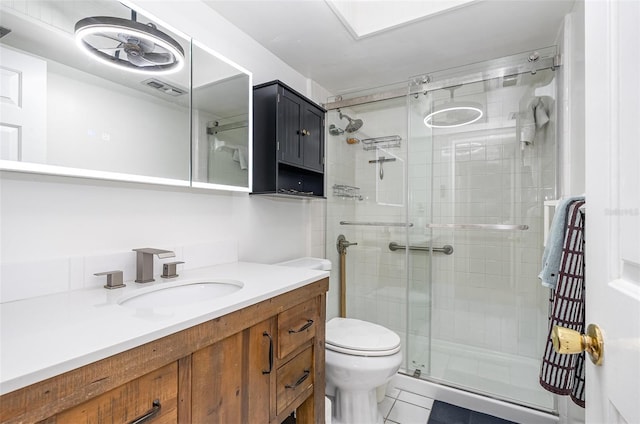 4850 Ocean Beach Blvd Unit 208, Cocoa Beach, FL 32931 - full bathroom featuring toilet, a stall shower, vanity, and tile patterned flooring