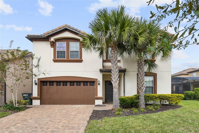 8801 Macapa Dr, Kissimmee, FL 34747 - view of front of home with an attached garage, stucco siding, and decorative driveway