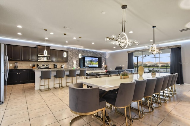 8801 Macapa Dr, Kissimmee, FL 34747 - dining area featuring light tile patterned floors, recessed lighting, and a chandelier