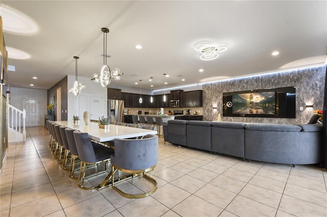 8801 Macapa Dr, Kissimmee, FL 34747 - dining area featuring light tile patterned floors, stairs, recessed lighting, and a chandelier