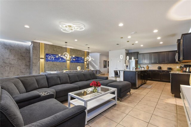 8801 Macapa Dr, Kissimmee, FL 34747 - living area with light tile patterned floors, recessed lighting, and a chandelier