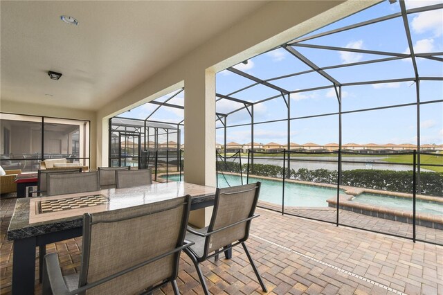 8801 Macapa Dr, Kissimmee, FL 34747 - view of patio / terrace with glass enclosure, a water view, and a pool with connected hot tub