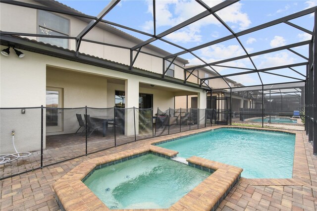 8801 Macapa Dr, Kissimmee, FL 34747 - view of pool with a pool with connected hot tub, a patio area, and a lanai