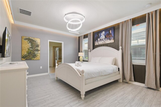8801 Macapa Dr, Kissimmee, FL 34747 - bedroom featuring baseboards and light wood finished floors