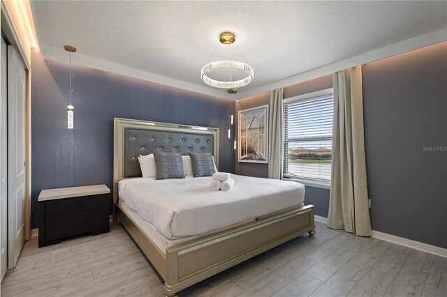 8801 Macapa Dr, Kissimmee, FL 34747 - bedroom featuring light wood-type flooring and baseboards