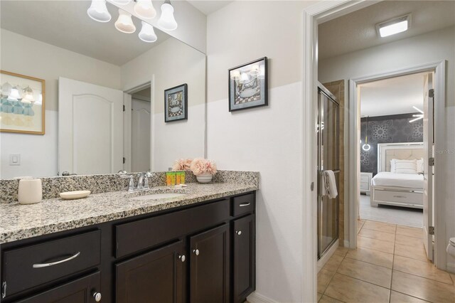 8801 Macapa Dr, Kissimmee, FL 34747 - full bath featuring vanity, a stall shower, tile patterned floors, and ensuite bathroom