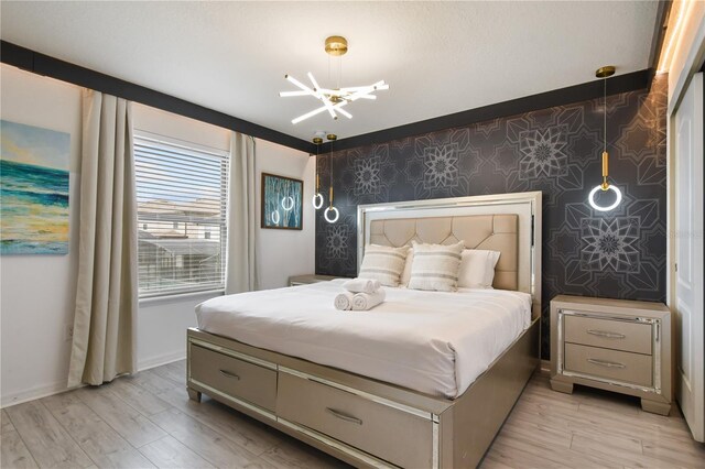8801 Macapa Dr, Kissimmee, FL 34747 - bedroom featuring wallpapered walls, a chandelier, light wood finished floors, and baseboards