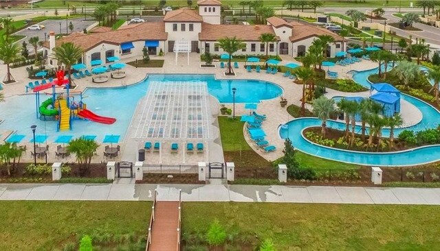 8801 Macapa Dr, Kissimmee, FL 34747 - view of pool featuring a water play area, a gate, and a water slide