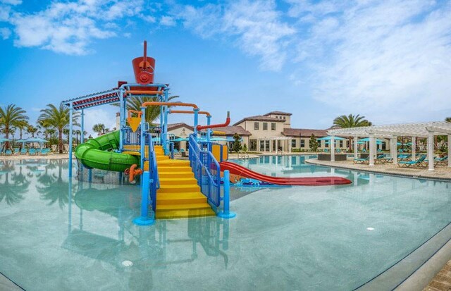 8801 Macapa Dr, Kissimmee, FL 34747 - community pool featuring a water play area, a pergola, and a water slide