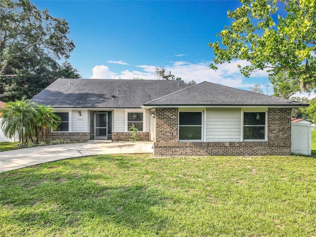 4942 Eden View Ct, Orlando, FL 32810 - single story home with brick siding, a front lawn, and a shingled roof
