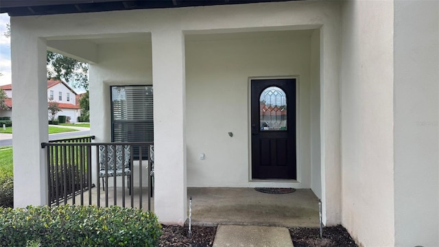 16631 Lazy Breeze Loop, Clermont, FL 34714 - property entrance with stucco siding and a porch