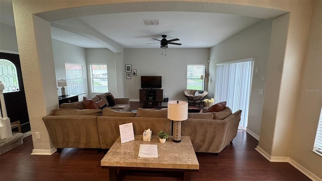 16631 Lazy Breeze Loop, Clermont, FL 34714 - living room featuring dark wood finished floors, ceiling fan, baseboards, and arched walkways