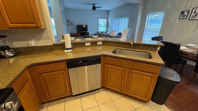 16631 Lazy Breeze Loop, Clermont, FL 34714 - kitchen with appliances with stainless steel finishes, a sink, a peninsula, and brown cabinetry