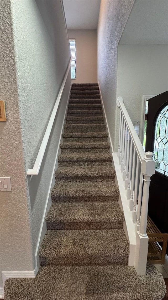 16631 Lazy Breeze Loop, Clermont, FL 34714 - stairs featuring a textured wall, carpet floors, and baseboards
