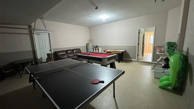 16631 Lazy Breeze Loop, Clermont, FL 34714 - recreation room featuring water heater, a textured ceiling, billiards table, concrete block wall, and baseboards
