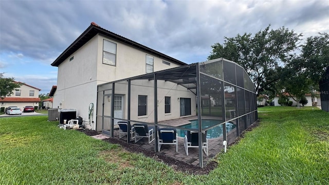 16631 Lazy Breeze Loop, Clermont, FL 34714 - back of property featuring a lawn, stucco siding, an outdoor pool, and cooling unit