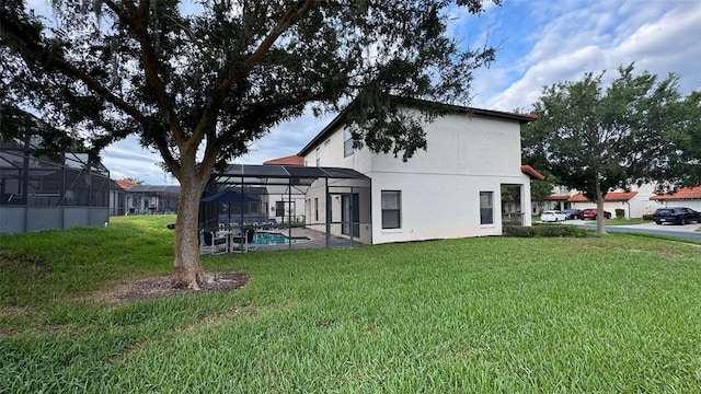 16631 Lazy Breeze Loop, Clermont, FL 34714 - back of house with a yard, stucco siding, an outdoor pool, and a lanai