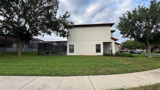 16631 Lazy Breeze Loop, Clermont, FL 34714 - view of side of property with a lawn, stucco siding, and a lanai