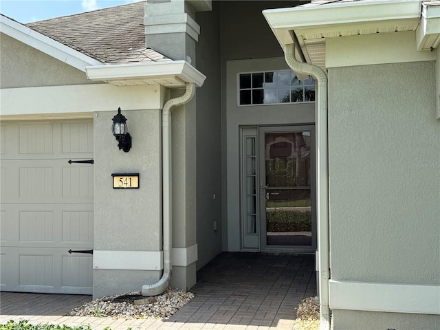 541 Arena Dr, Davenport, FL 33837 - entrance to property with a shingled roof and stucco siding