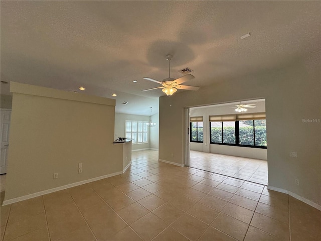 541 Arena Dr, Davenport, FL 33837 - unfurnished room with a ceiling fan, a textured ceiling, light tile patterned flooring, recessed lighting, and baseboards