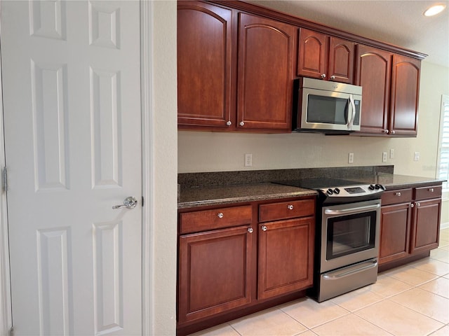 541 Arena Dr, Davenport, FL 33837 - kitchen with appliances with stainless steel finishes, light tile patterned flooring, and recessed lighting