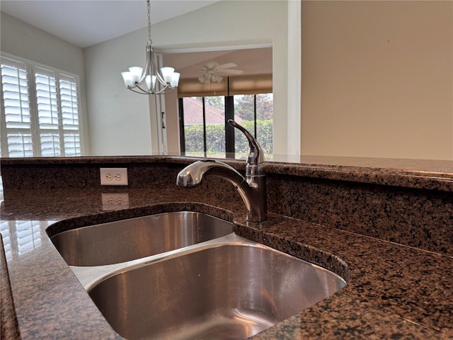 541 Arena Dr, Davenport, FL 33837 - kitchen view of a sink, a chandelier, hanging light fixtures, and dark stone countertops