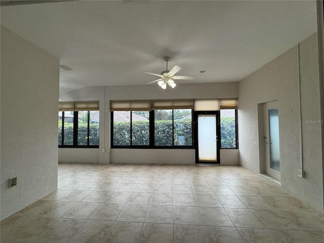 541 Arena Dr, Davenport, FL 33837 - tiled spare room with a textured wall, healthy amount of natural light, and ceiling fan