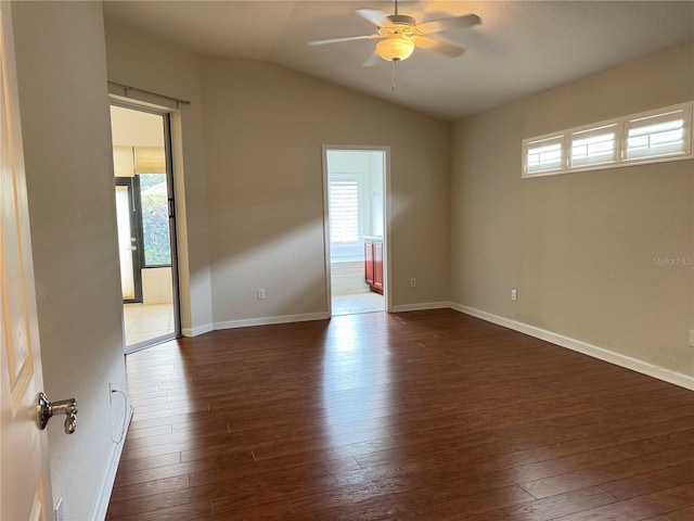 541 Arena Dr, Davenport, FL 33837 - spare room with dark wood-style flooring, a ceiling fan, lofted ceiling, and plenty of natural light