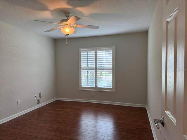 541 Arena Dr, Davenport, FL 33837 - empty room with dark wood-style flooring, a ceiling fan, baseboards, and a textured ceiling