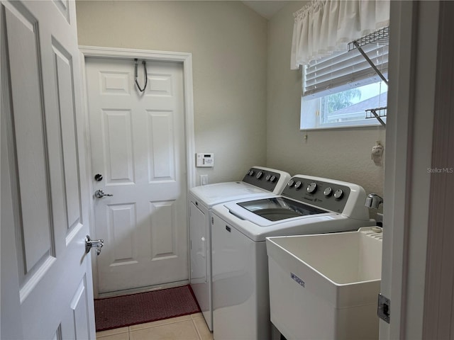 541 Arena Dr, Davenport, FL 33837 - laundry room with separate washer and dryer and light tile patterned floors