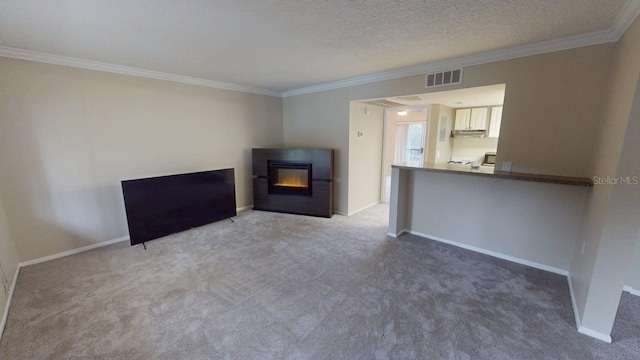 145 Oyster Bay Cir Unit 200, Altamonte Springs, FL 32701 - unfurnished living room featuring crown molding, carpet floors, a glass covered fireplace, baseboards, and a textured ceiling