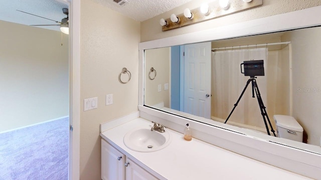 145 Oyster Bay Cir Unit 200, Altamonte Springs, FL 32701 - bathroom featuring ceiling fan, vanity, a textured ceiling, and toilet
