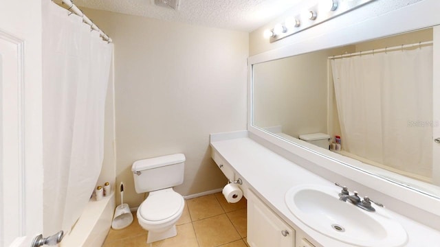 145 Oyster Bay Cir Unit 200, Altamonte Springs, FL 32701 - bathroom featuring toilet, vanity, a textured ceiling, tile patterned flooring, and a shower with curtain