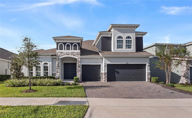 4413 Lions Gate Ave, Clermont, FL 34711 - view of front of home with stucco siding, decorative driveway, stone siding, and a shingled roof
