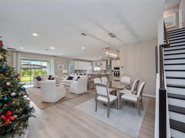 4413 Lions Gate Ave, Clermont, FL 34711 - dining area featuring stairs, light wood finished floors, and recessed lighting