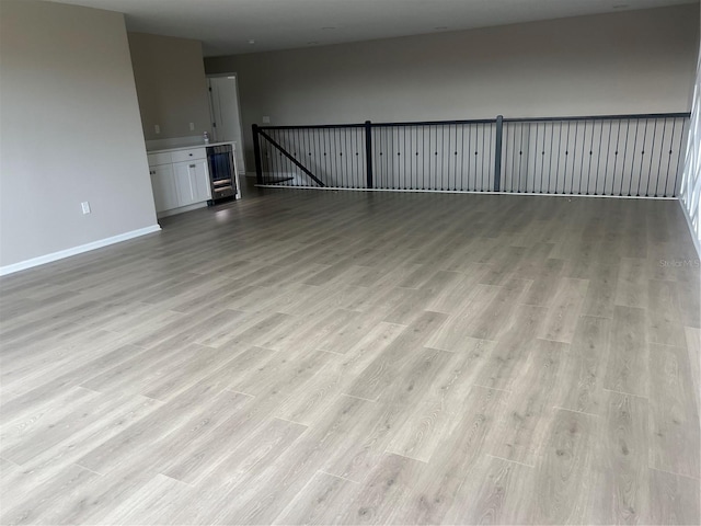 4413 Lions Gate Ave, Clermont, FL 34711 - unfurnished living room featuring light wood-type flooring and baseboards